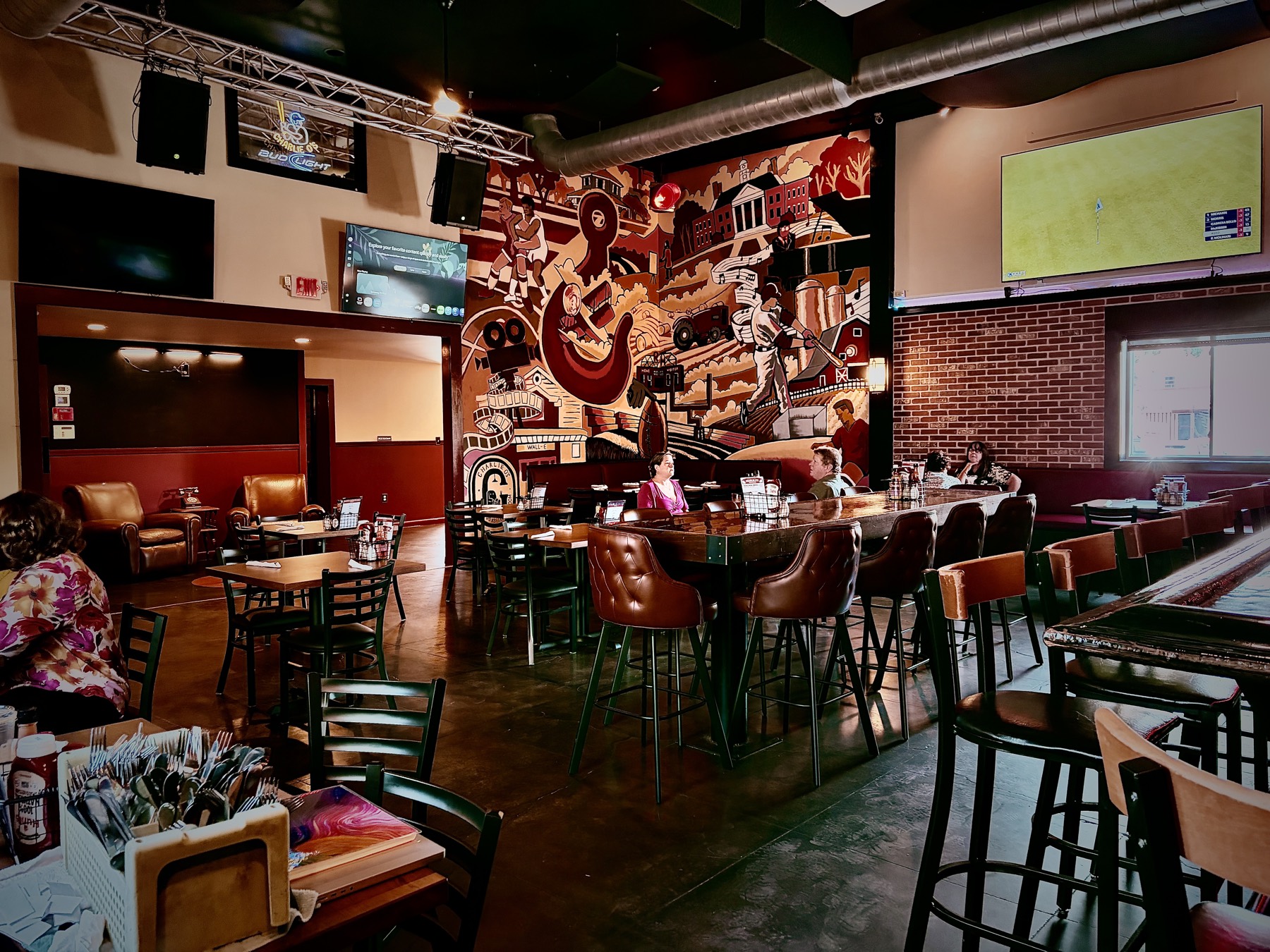The bar room at Charlie O's after the renovation, with the Red Hook mural behind the bar